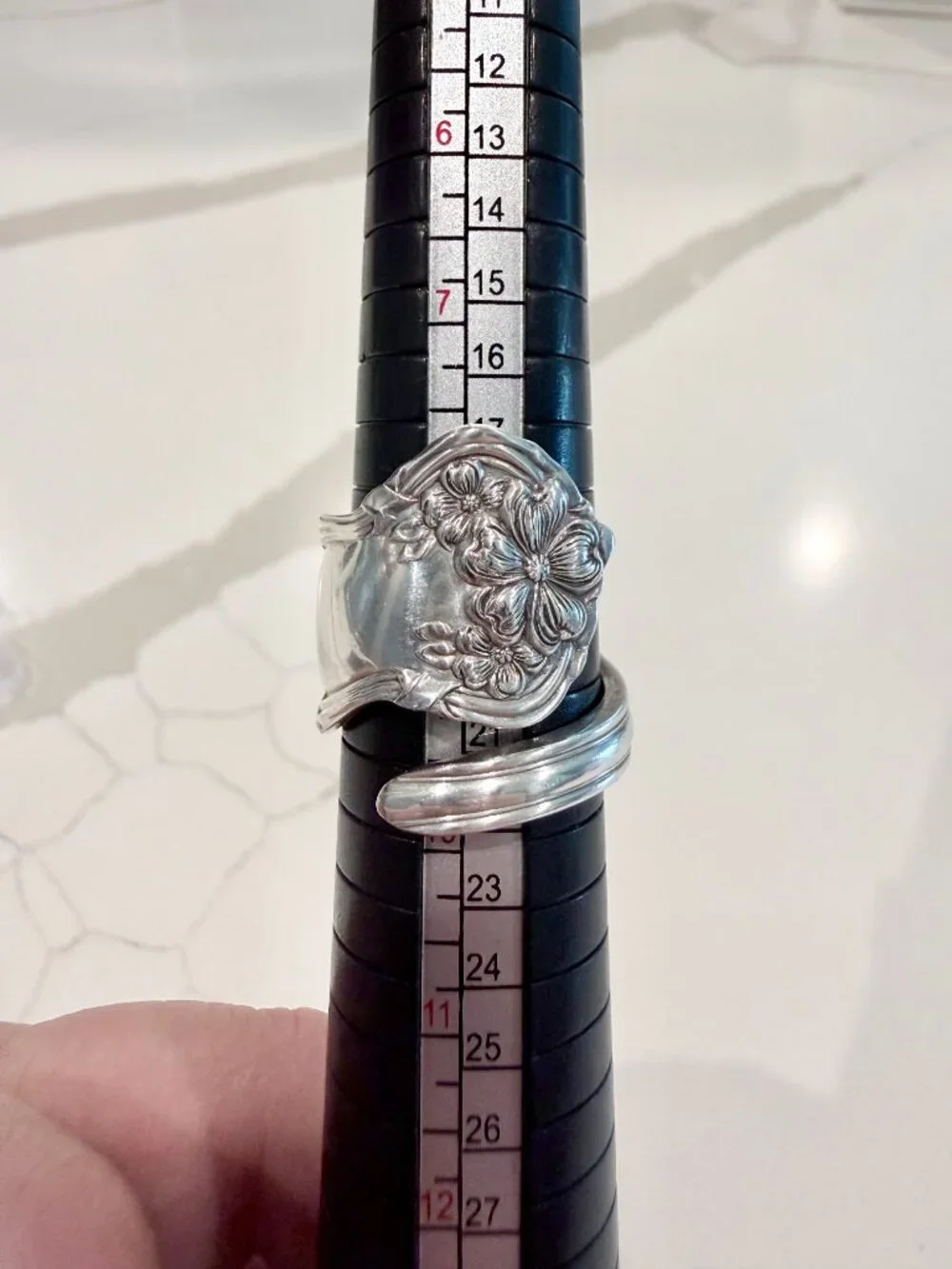 Spoon ring features an ornate floral design